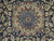 Close-up of rust and blue lobed central medallion with arabesque tracery on navy ground