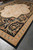 12 x 15 black Aubusson area rug displayed at an angle across concrete showroom floor
