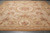 Beige Aubusson rug laid flat showing rose bouquets, acanthus scrolls and camel outer border