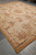 Full length angled photo of this new hand woven Aubusson rug in beige and gold