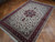 6'7" x 9'8" wool and silk Tabriz rug photographed at an angle on parquet flooring