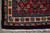 Corner detail of red main border, ivory turtle guard band and navy outer edge