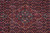 Close-up of the light blue and red central medallion inside dense Herati fish lattice