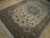 7x10 wool and silk Persian Tabriz rug angled on wood floor, ivory ground, rust flowers
