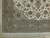 Corner detail showing sage green main border, rosette guard stripes and ivory cotton fringe