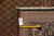 Back tag and tape measure confirming 11'6" x 16'6" size on this hand-knotted Tabriz rug
