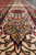 Border close-up of camel palmette and cartouche motifs woven in wool on ivory ground