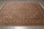 8'4" x 10'1" hand-knotted wool and silk rug displayed flat on grey tile floor