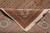 Folded corner showing the reverse weave and knot density beside the ivory cotton fringe
