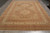 9x12 Haji Jalili wool rug photographed lengthwise, ivory borders framing a brown floral field