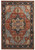 Full overhead view of rust and navy Serapi rug with geometric star medallion and floral border