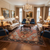 Formal living room styled with the 9'9" x 14' Serapi rug beneath a mahogany coffee table
