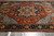 Angled floor view showing sky blue spandrels, soft rust field and indigo main border detail