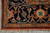 Corner detail of the navy border with turtle palmettes, rosettes and hand-knotted cream fringe