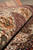 Rolled edge close-up revealing dense wool pile, green palmettes and deep burgundy border tones