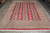 Full overhead view of hand-knotted wool Jaldar rug showing camel diamond columns on raspberry red ground