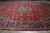 Angled floor view showing crimson field, navy willow tree border and dense floral vinework detail