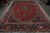 Full length view of the 11x17 Tabriz rug laid flat in the warehouse showroom