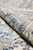 Rolled edge highlighting soft wool pile, silk accents and the light blue guard borders