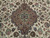 Close-up of the central medallion, green rosette and curling vine scrolls on cream ground