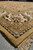 Ivory main border and gold outer band photographed from floor level along fringed end
