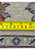 Tape measure on the back of an 8x11 Yazd wool rug showing 260 to 280 knots per square inch