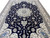 Large 13x19 Persian Nain rug viewed lengthwise, navy field framed by ivory floral border