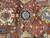 Detail of navy rosette medallion surrounded by salmon vines and ivory palmettes on rust ground