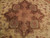 Close-up of brown 8 point star medallion with salmon rosette and green floral cartouches
