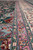 Pink and green guard borders run beside ivory main border in this raised pile view