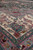 Perspective view of cream border and pink outer stripe showing plush hand-knotted wool silk pile