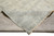 Folded corner showing the even hand-knotted back and hand-tied fringe of this Indian wool rug
