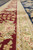 9'10" x 14' rug border in sharp focus, burgundy floral vine and gold zigzag guards