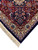 Navy outer border, ivory guard stripe and clean ivory fringe along the rug end
