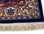 Close view of ivory main border with blue palmette and rose flower guard stripes