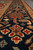 Navy border detail with red cross rosettes, camel guard stripe and thick hand-knotted wool pile