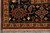 Corner of the square Serapi rug with gold guard border and hand-tied ivory fringe
