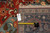 Back of the 10' x 10' rug with tape measure and genuine hand woven Oriental rug tag