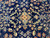Small gold lozenge at the center of the navy Sarouk field, photographed close up