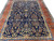 Length view of the indigo field showing dense palmette, rosette and leafy vine patterning