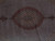Close view of the rust medallion and dense Herati fish lattice woven in wool and silk