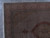 Corner detail showing salmon floral border, ivory guard stripes and hand-knotted fringe on grey tile