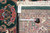 Back of the rug with dealer tag, tape measure and visible knot rows confirming handmade construction
