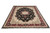 9 x 12 wool and silk Oriental rug photographed at an angle on white studio background