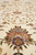 Detail of a large rose palmette in lavender and apricot on the ivory field