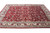 10'5" x 14'7" Indian Kashan design rug photographed at an angle showing dense wool pile