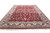 10'5" x 14'7" red Kashan design rug angled from the fringe end showing ivory border