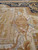 Ivory inner field with ribbon swags, tassels and pastel florals around the camel center panel