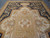 Crowned crest medallion and ivory quatrefoil reserve filling the center of this palace size rug
