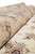 Rolled rug showing silk highlighted floral sprays on beige border above ivory field pile